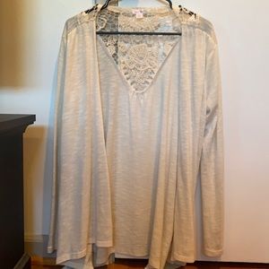 Cream colored long sleeve cardigan with open lace design in back